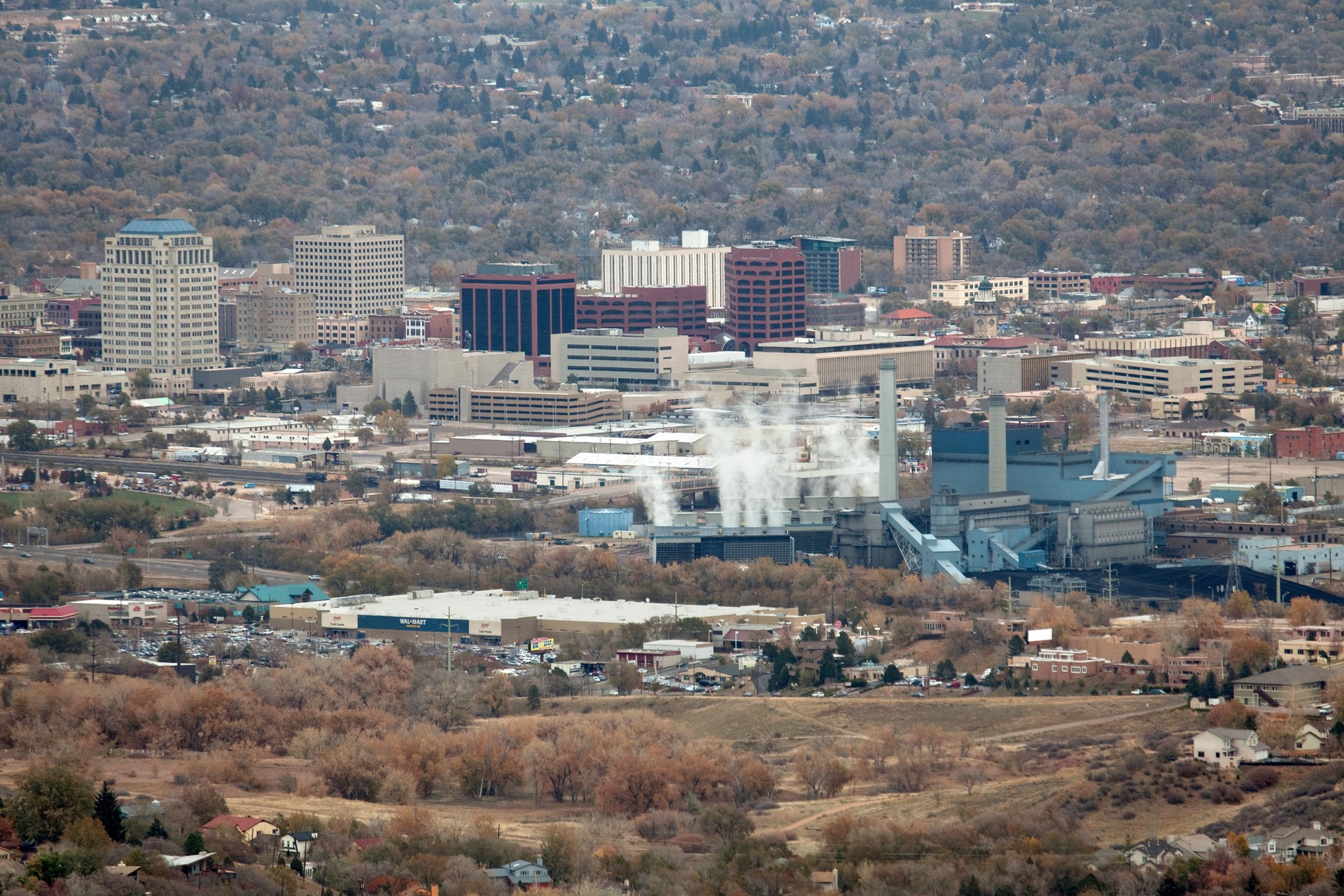 Colorado Springs city skyscrapers and coal power plant steam